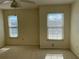 Carpeted bedroom featuring dual windows providing natural light at 1512 Chateaux De Ville Ct, Clearwater, FL 33764