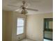 Bedroom showcasing carpet flooring, a ceiling fan, and a doorway to a bathroom at 1512 Chateaux De Ville Ct, Clearwater, FL 33764