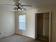 Carpeted bedroom featuring a window for natural light and a closet at 1512 Chateaux De Ville Ct, Clearwater, FL 33764