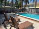 Inviting community pool with lounge chairs and tables for relaxing at 1512 Chateaux De Ville Ct, Clearwater, FL 33764