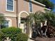 Inviting townhome with arched entry and well-maintained landscaping at 1512 Chateaux De Ville Ct, Clearwater, FL 33764