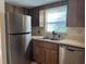 Functional kitchen featuring stainless steel refrigerator and ample counter space at 1512 Chateaux De Ville Ct, Clearwater, FL 33764