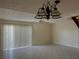 Bright living space with tile floors, sliding door, and modern ceiling fan at 1512 Chateaux De Ville Ct, Clearwater, FL 33764