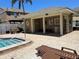 A cabana structure with benches and several lounge chairs beside the pool at 1512 Chateaux De Ville Ct, Clearwater, FL 33764