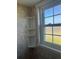 Corner shower features a corner shelf and a window at 1512 Chateaux De Ville Ct, Clearwater, FL 33764