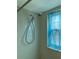 Modern shower with adjustable head and tile surround near a sunny window at 1512 Chateaux De Ville Ct, Clearwater, FL 33764