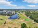 Aerial view featuring the golf course and lakeside views at 1515 12Th Se Ct # 55, Largo, FL 33771
