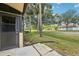 Back porch of a home with trees and green yard at 1515 12Th Se Ct # 55, Largo, FL 33771