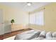 Staged bedroom featuring a dresser, soft lighting, and natural light from the window at 1515 12Th Se Ct # 55, Largo, FL 33771