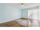 Well-lit bedroom with wood-look floors, ceiling fan, and a large rug at 1515 12Th Se Ct # 55, Largo, FL 33771