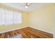 Bright bedroom with hardwood floors, natural light, and a ceiling fan at 1515 12Th Se Ct # 55, Largo, FL 33771