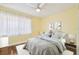Staged bedroom with a comfortable bed, neutral color scheme, and hardwood floors at 1515 12Th Se Ct # 55, Largo, FL 33771