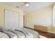 Bright bedroom featuring a ceiling fan, closet and wood-look laminate flooring at 1515 12Th Se Ct # 55, Largo, FL 33771