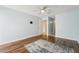 Light bedroom with wood-look floors, ceiling fan, and a rug at 1515 12Th Se Ct # 55, Largo, FL 33771