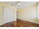 Bedroom features hardwood floors, closet and door at 1515 12Th Se Ct # 55, Largo, FL 33771