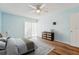 Charming bedroom with wood-look floors, fan, and sliding door at 1515 12Th Se Ct # 55, Largo, FL 33771