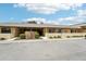 Charming condo exterior featuring tan stucco, manicured landscaping and a stone fountain at 1515 12Th Se Ct # 55, Largo, FL 33771