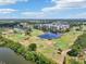 Scenic aerial of golf course, a tranquil lake, and well-maintained greens and fairways at 1515 12Th Se Ct # 55, Largo, FL 33771
