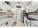Updated kitchen with white cabinets, stainless steel appliances, and modern fixtures at 1515 12Th Se Ct # 55, Largo, FL 33771