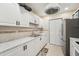 Bright kitchen featuring white cabinets, marble countertops, and a stainless steel refrigerator at 1515 12Th Se Ct # 55, Largo, FL 33771
