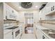 Bright kitchen view leading to a dining area, featuring sleek countertops and modern appliances at 1515 12Th Se Ct # 55, Largo, FL 33771