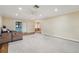 Spacious living room with carpeting, ceiling fan and slider doors that lead to the lanai at 1515 12Th Se Ct # 55, Largo, FL 33771
