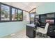 Bright sun room featuring multiple windows and a built-in desk with cabinetry at 1515 12Th Se Ct # 55, Largo, FL 33771
