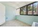 Bright sunroom features tile floor, pale blue walls, and large windows to let the Florida sunshine in at 1515 12Th Se Ct # 55, Largo, FL 33771