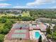 Community amenities showing tennis courts and swimming pool with view of surrounding golf course at 1515 12Th Se Ct # 55, Largo, FL 33771