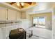 Dining area needing remodel with tile floors, white cabinets, and sliding glass door to patio at 1671 Cape Ann Ne Ave # 4, St Petersburg, FL 33702