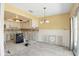 Bright dining room needs remodeling, featuring tile floors, chandelier, and access to the kitchen at 1671 Cape Ann Ne Ave # 4, St Petersburg, FL 33702