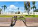 Community's charming wooden dock leading to waterfront with benches and palm trees at 1671 Cape Ann Ne Ave # 4, St Petersburg, FL 33702