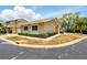 Inviting exterior of a one-story home with a well-maintained lawn, neatly trimmed bushes, and a neutral color palette at 1671 Cape Ann Ne Ave # 4, St Petersburg, FL 33702