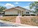 Inviting one-story home with brick accents, tidy landscaping, and a brick walkway leading to the front door at 1671 Cape Ann Ne Ave # 4, St Petersburg, FL 33702
