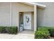 Close-up of a front door surrounded by brick and siding, showcasing a welcoming entrance with green shrubs at 1671 Cape Ann Ne Ave # 4, St Petersburg, FL 33702