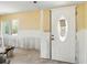 Renovation scene: a bright room with yellow walls and a decorative glass front door, ready for finishing touches at 1671 Cape Ann Ne Ave # 4, St Petersburg, FL 33702