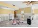 Open-concept living room needing remodeling boasts lots of natural light and unique ceiling fan at 1671 Cape Ann Ne Ave # 4, St Petersburg, FL 33702
