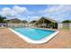 View of the community pool with covered patio and seating, ideal for outdoor gatherings and enjoyment at 1671 Cape Ann Ne Ave # 4, St Petersburg, FL 33702