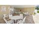This image captures the community pool's seating area with multiple tables and chairs at 1671 Cape Ann Ne Ave # 4, St Petersburg, FL 33702