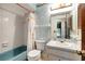 Small bathroom with blue tub and marble counter and vanity with a decorative mirror at 18426 Sterling Silver Cir, Lutz, FL 33549