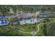 Aerial view of community clubhouse, pool, tennis courts, and lush landscaping at 1845 Ridgemore St, North Port, FL 34289