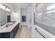 Well-lit bathroom with double vanity, marble walk-in shower, and modern fixtures and fittings at 1845 Ridgemore St, North Port, FL 34289