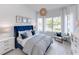 Bright bedroom featuring shiplap walls, a blue velvet bed, and lots of natural light at 1845 Ridgemore St, North Port, FL 34289