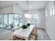 Bright dining room with view of the lush, green backyard through large window and sliding glass door at 1845 Ridgemore St, North Port, FL 34289