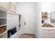 Bright entryway featuring built-in shelving, hooks, and bench seating at 1845 Ridgemore St, North Port, FL 34289
