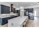 Stylish kitchen with navy cabinets, white quartz countertops, stainless steel appliances, and a spacious center island at 1845 Ridgemore St, North Port, FL 34289