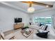 Bright living room with a large sliding door, comfortable seating, modern decor, and natural light at 1845 Ridgemore St, North Port, FL 34289