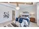 Bright main bedroom with wood beams, modern chandelier, and en-suite bathroom featuring a marble walk-in shower at 1845 Ridgemore St, North Port, FL 34289