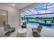 Screened in lanai with pool, lounge chairs, and lush green landscape at 1845 Ridgemore St, North Port, FL 34289