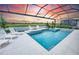Beautiful pool overlooking a sunset landscape with lounge seating at 1845 Ridgemore St, North Port, FL 34289